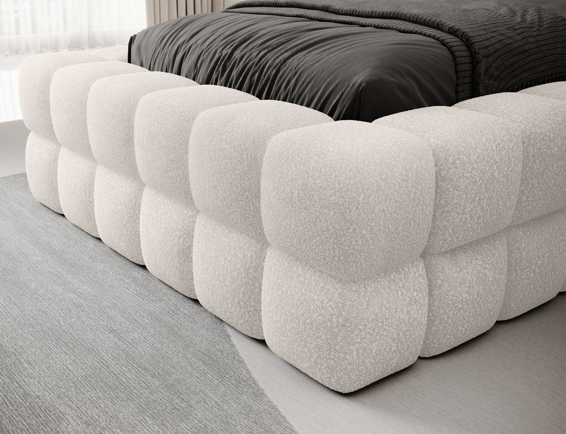 Białe łóżko Dizzle I 90x200 w tkaninie Jaffray 01, detal tapicerowanego boku – solidne wykonanie i nowoczesna stylistyka.