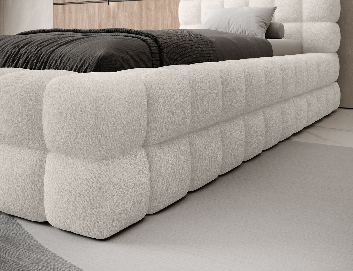 Łóżko Dizzle I jednoosobowe 90x200 w białej tkaninie Jaffray 01, detal narożnika – miękkie linie i elegancki charakter mebla.