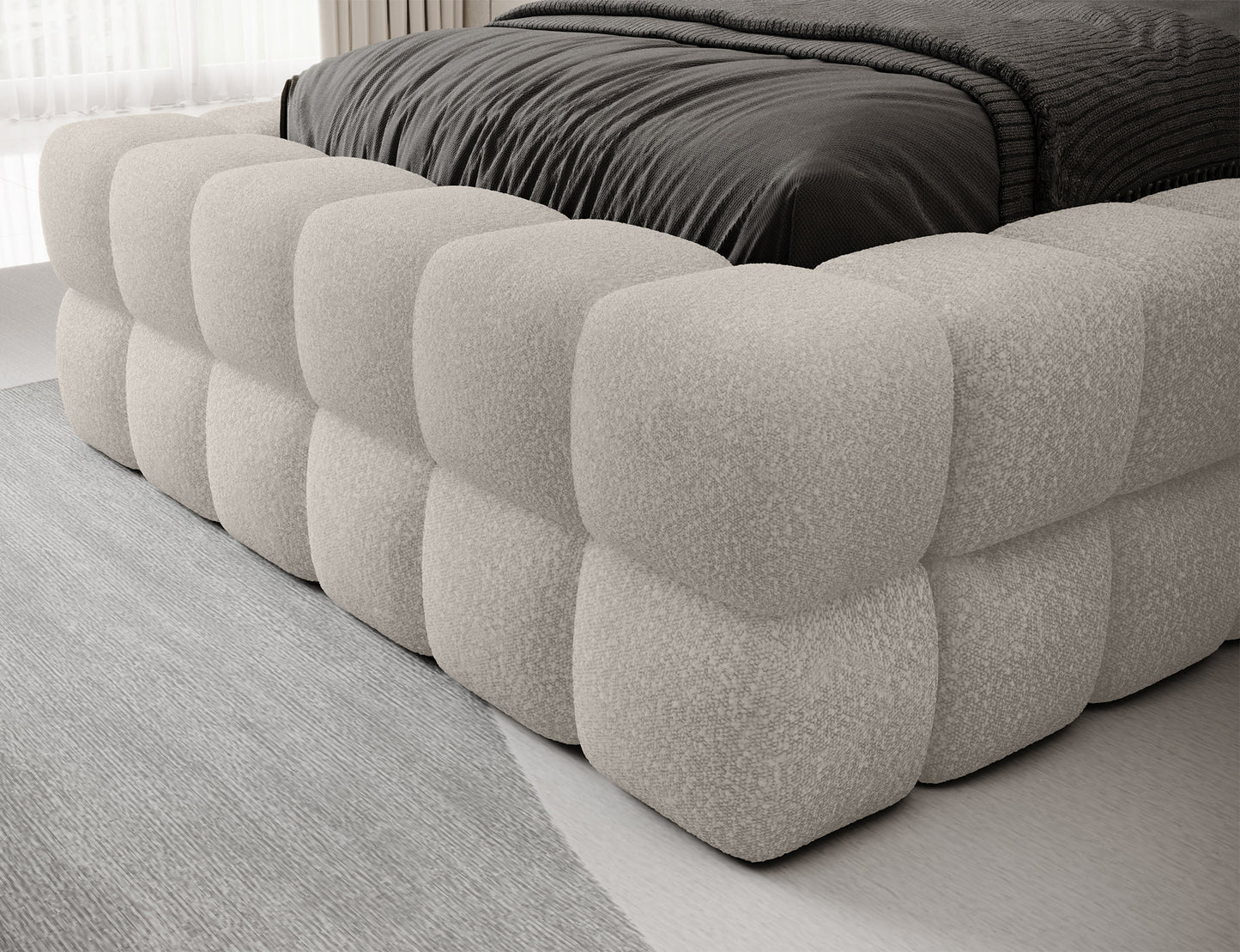 Detal łóżka Dizzle 90 w tkaninie Jaffray 18 jasnobeżowy, zbliżenie na tapicerowaną podstawę z charakterystycznym pikowaniem.