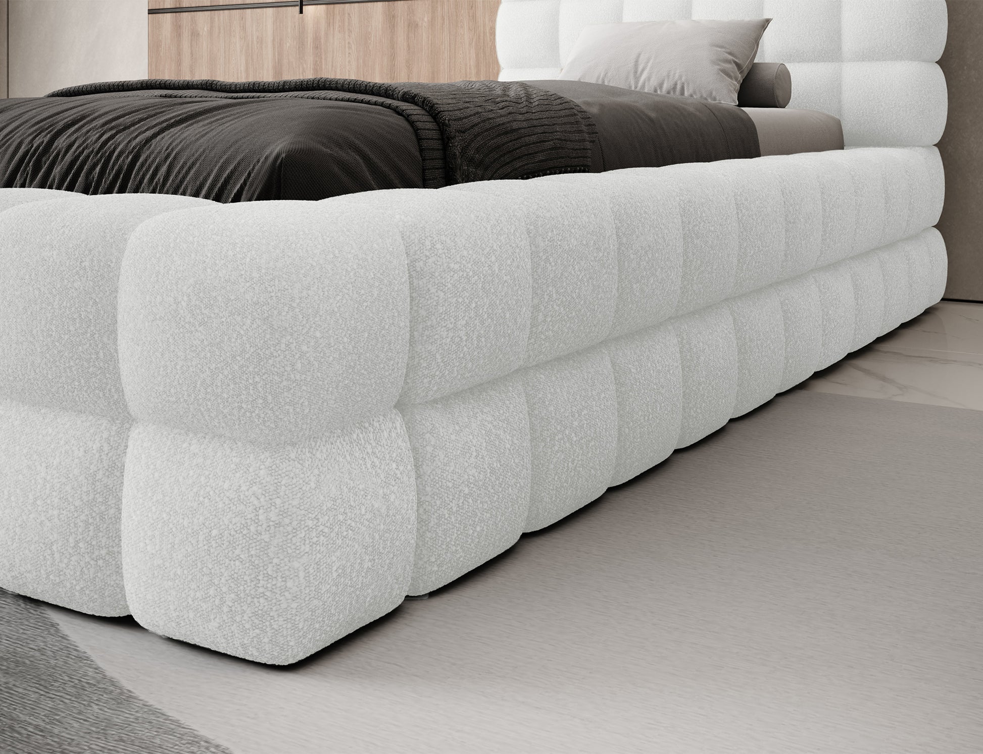 Detal narożnika łóżka Dizzle I 90x200 w tkaninie Royal 01 biały, miękka tapicerka o wyrazistej fakturze bouclé.