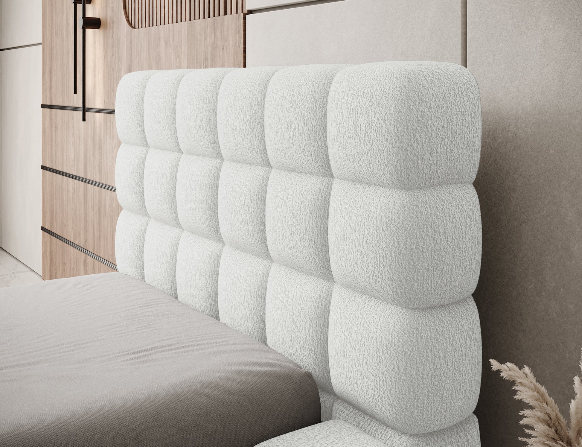 Wezgłowie łóżka Dizzle I 90x200 w tkaninie Royal 01 biały, zbliżenie na miękkie, geometryczne przeszycia tapicerki.