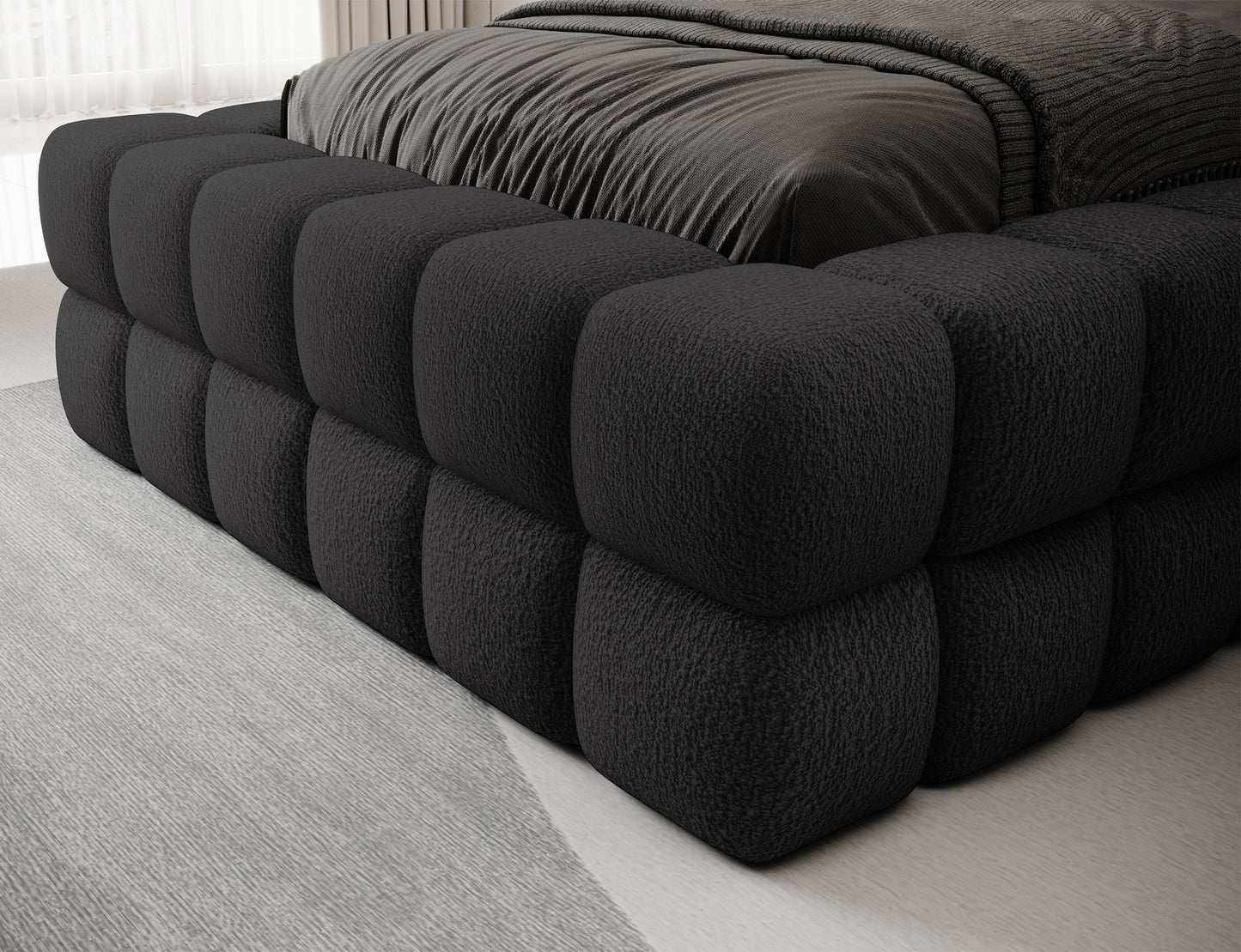 Detal dolnej części łóżka Dizzle I 90x200 w tkaninie Royal 05 ciemnoszary, wykończenie tapicerki z bliska.