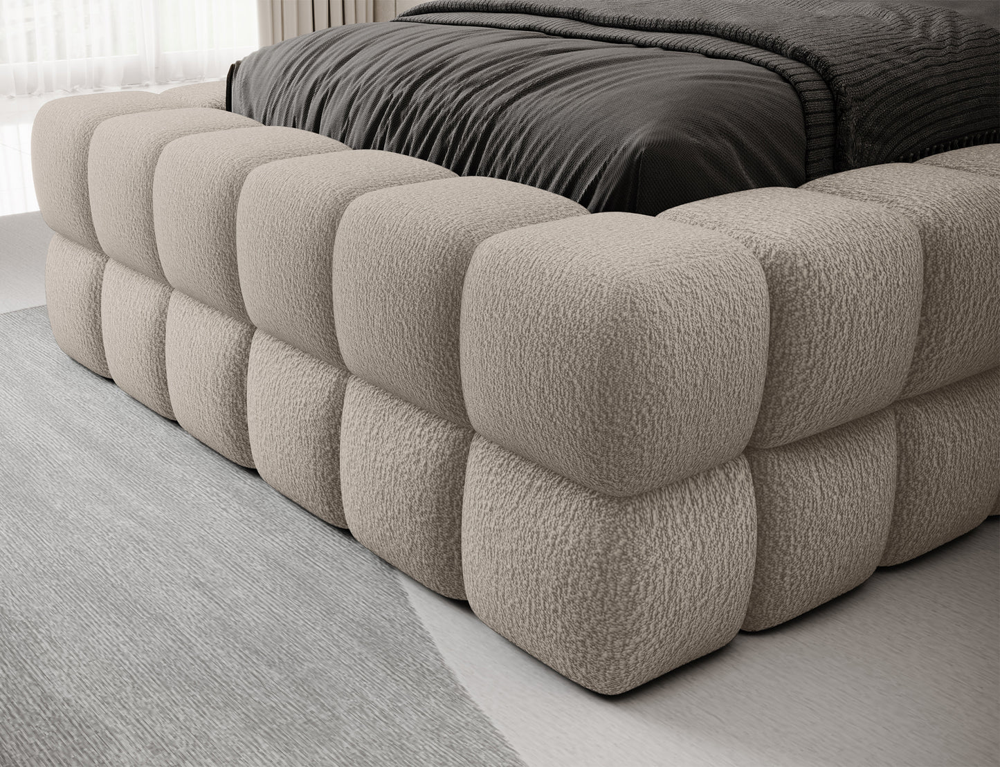 Tapicerowane łóżko Dizzle 90x200 w tkaninie Royal 18 jasnobeżowy, detal korpusu z pikowaną, miękką strukturą.