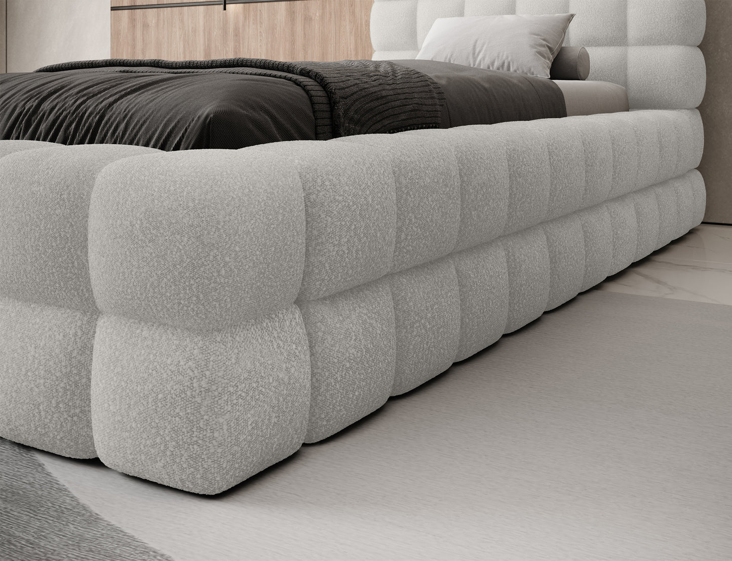 Zbliżenie na bok łóżka Dizzle I 90x200 w tkaninie beżowej Royal 20, tapicerowane z masywną i miękką ramą.