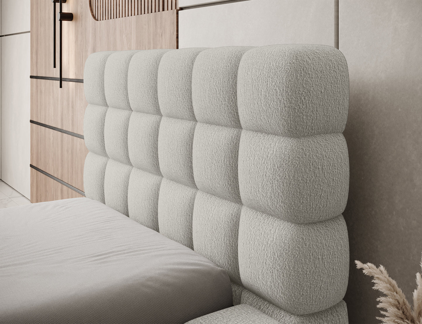 Zbliżenie na wezgłowie łóżka Dizzle I 90x200 w tkaninie Royal 20 beżowy, tapicerowane z geometrycznymi przeszyciami.