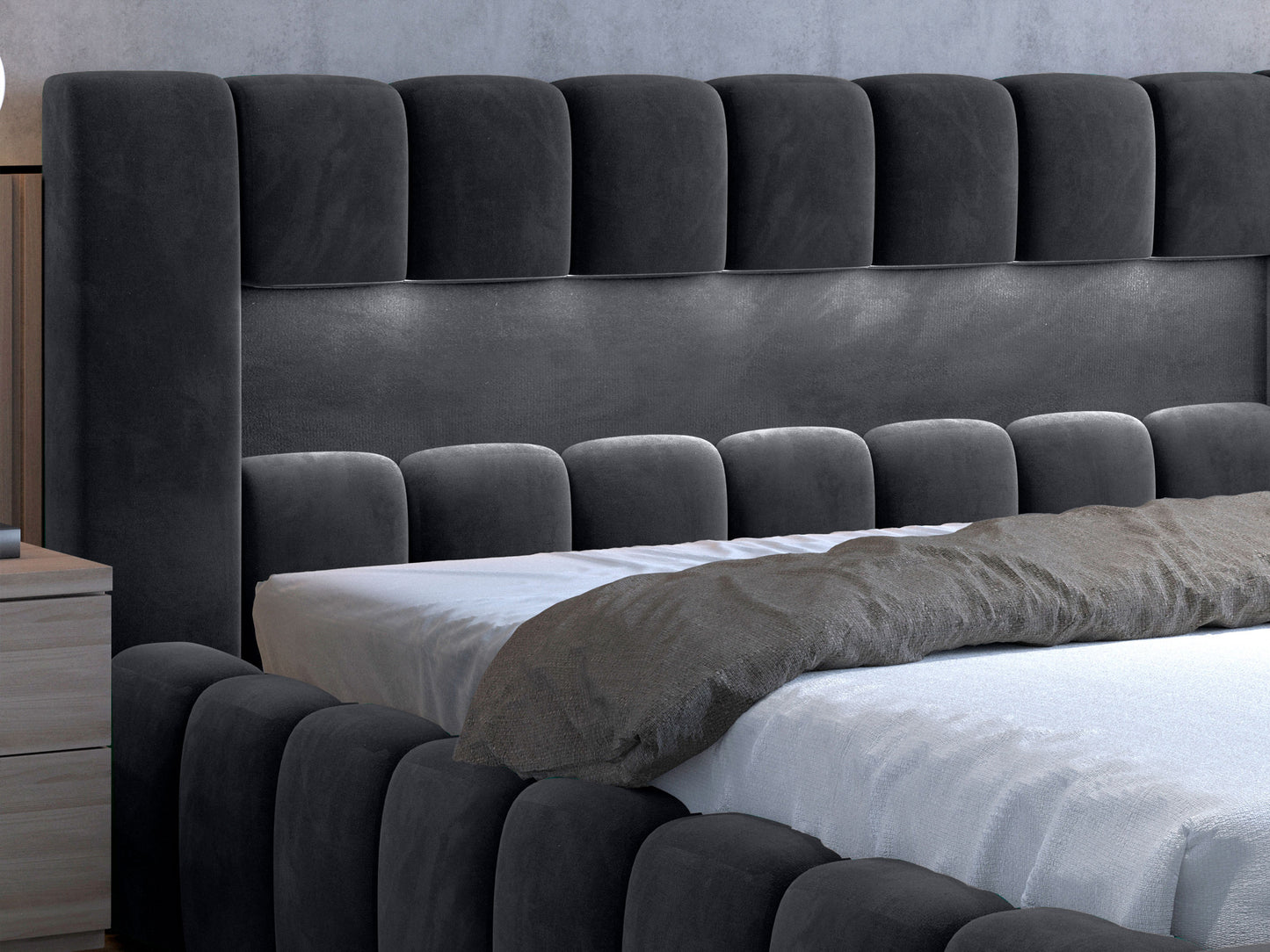 Bok łóżka Lamica w kolorze Monolith 85 szary z miękkim, tapicerowanym wykończeniem.