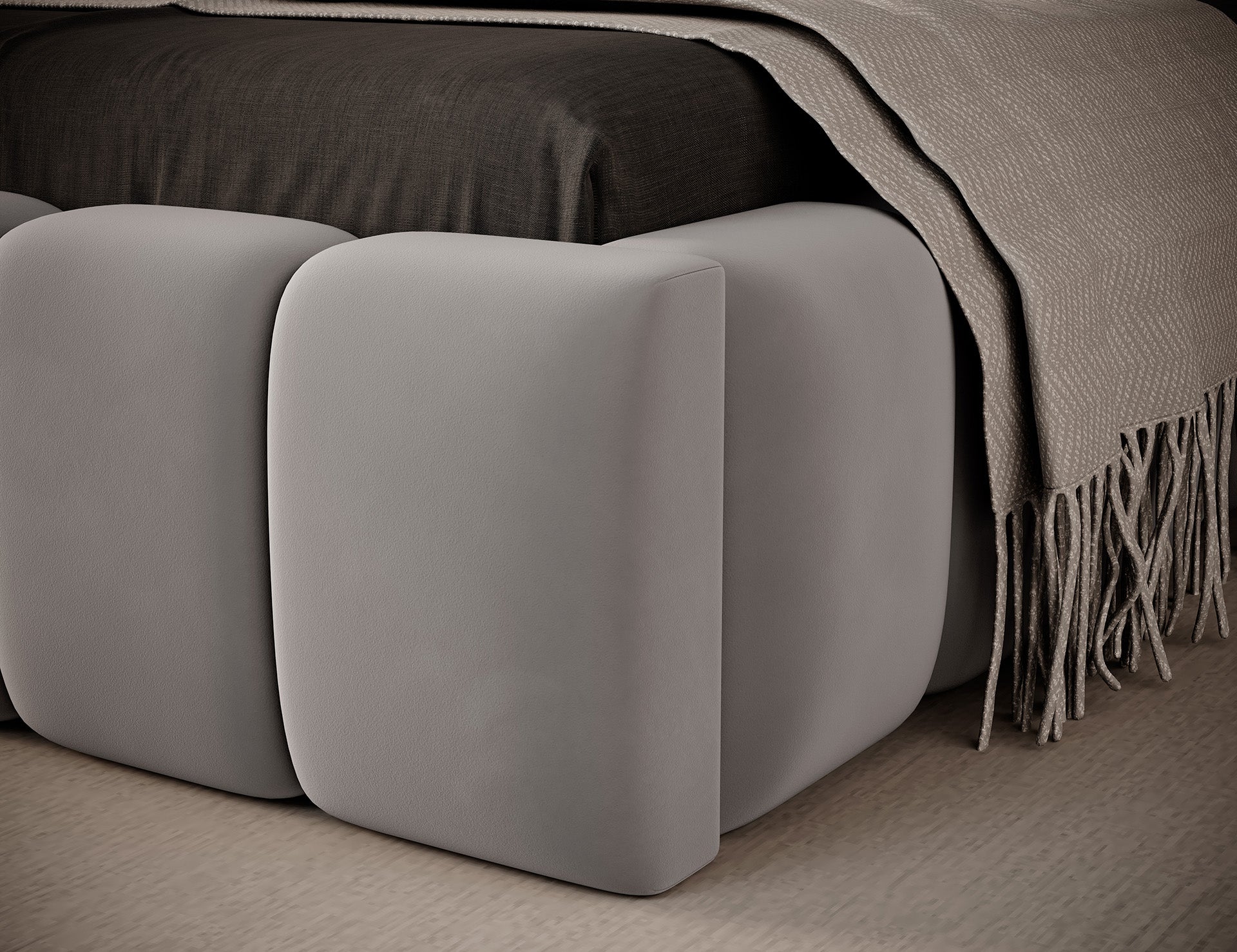 Zbliżenie narożnika dolnej części łóżka Lamica I Nube 03, pokazujące staranne wykończenie szwów i miękkie pikowanie.