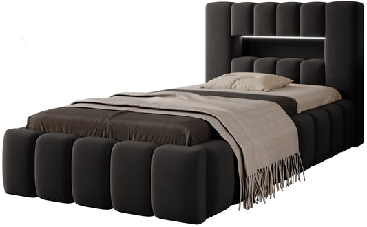 Łóżko Lamica I Nube 06 ciemnoszary (90×200 cm) widoczne z boku na białym tle, z charakterystycznymi, zaokrąglonymi panelami tapicerki.