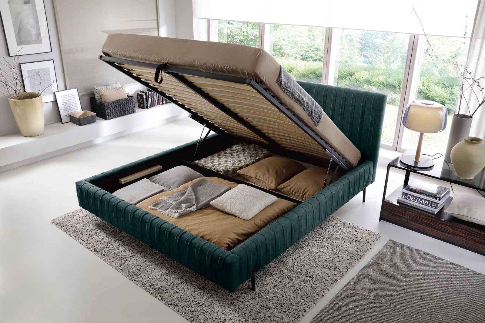 Niski kąt patrzenia na bok i czarną nogę łóżka Plissa 160×200 w kolorze Relax 38 zielony, stojące na jasnym dywanie.