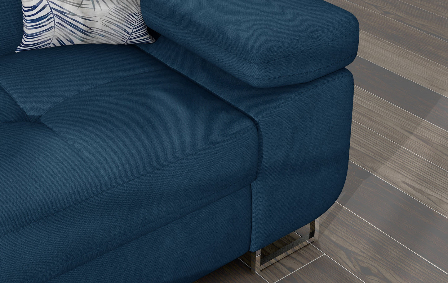 Zbliżenie na podłokietnik narożnika Armando w tkaninie Kronos 09 granatowy z dekoracyjną poduszką Botanical 80 w roślinny wzór.