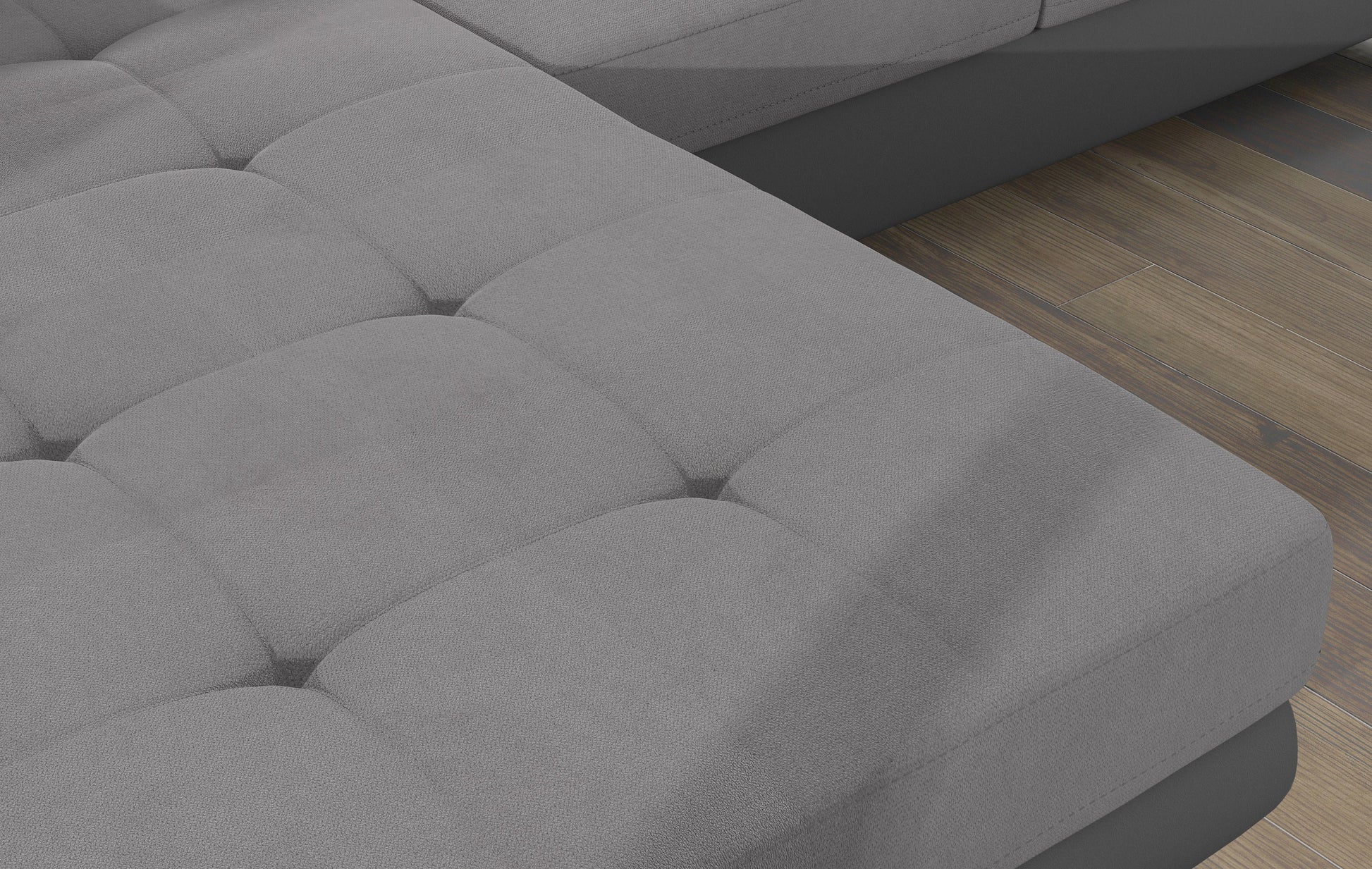 Zbliżenie na pikowane siedzisko narożnika Armando w tkaninie Soro 83 jasnoszary – wyraźna faktura materiału i poduszka Jungle 32.