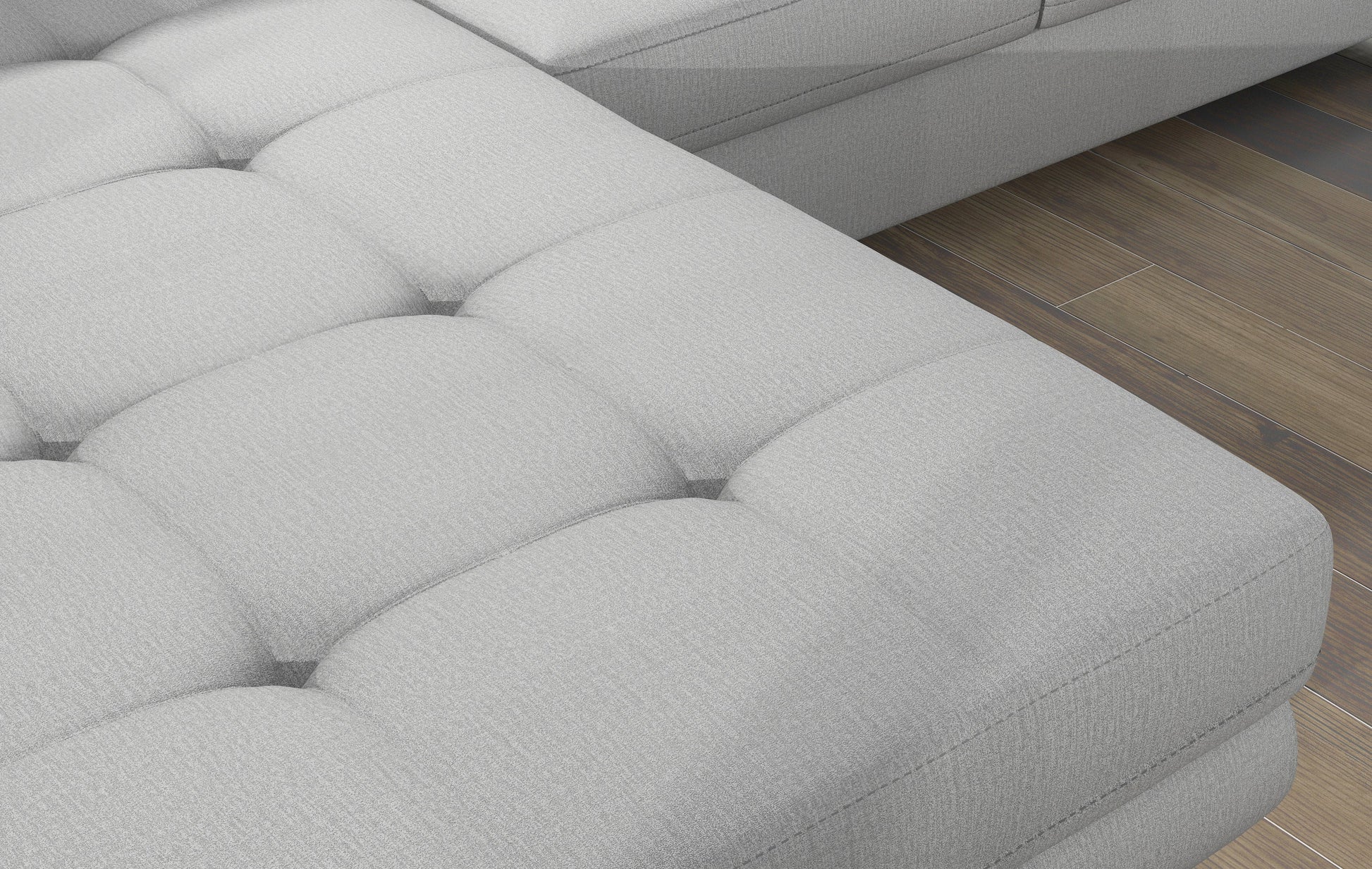 Zbliżenie na pikowane siedzisko narożnika Armando w tkaninie Monolith 84 jasnoszary – wyraźna aksamitna struktura materiału.