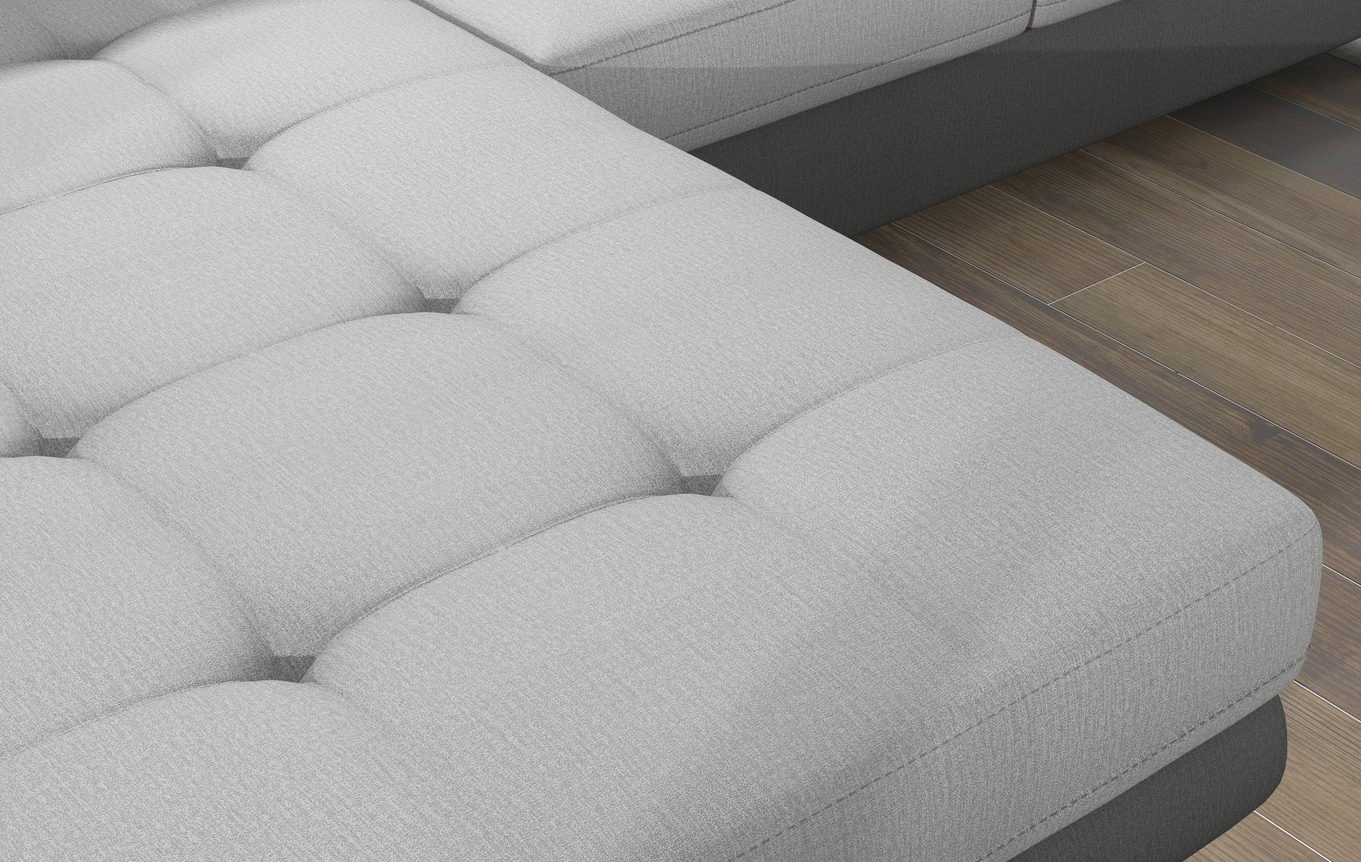 Zbliżenie na pikowane siedzisko narożnika Armando w tkaninach Monolith 84 jasnoszary i Monolith 97 ciemnoszary – wyraźna aksamitna struktura materiału.