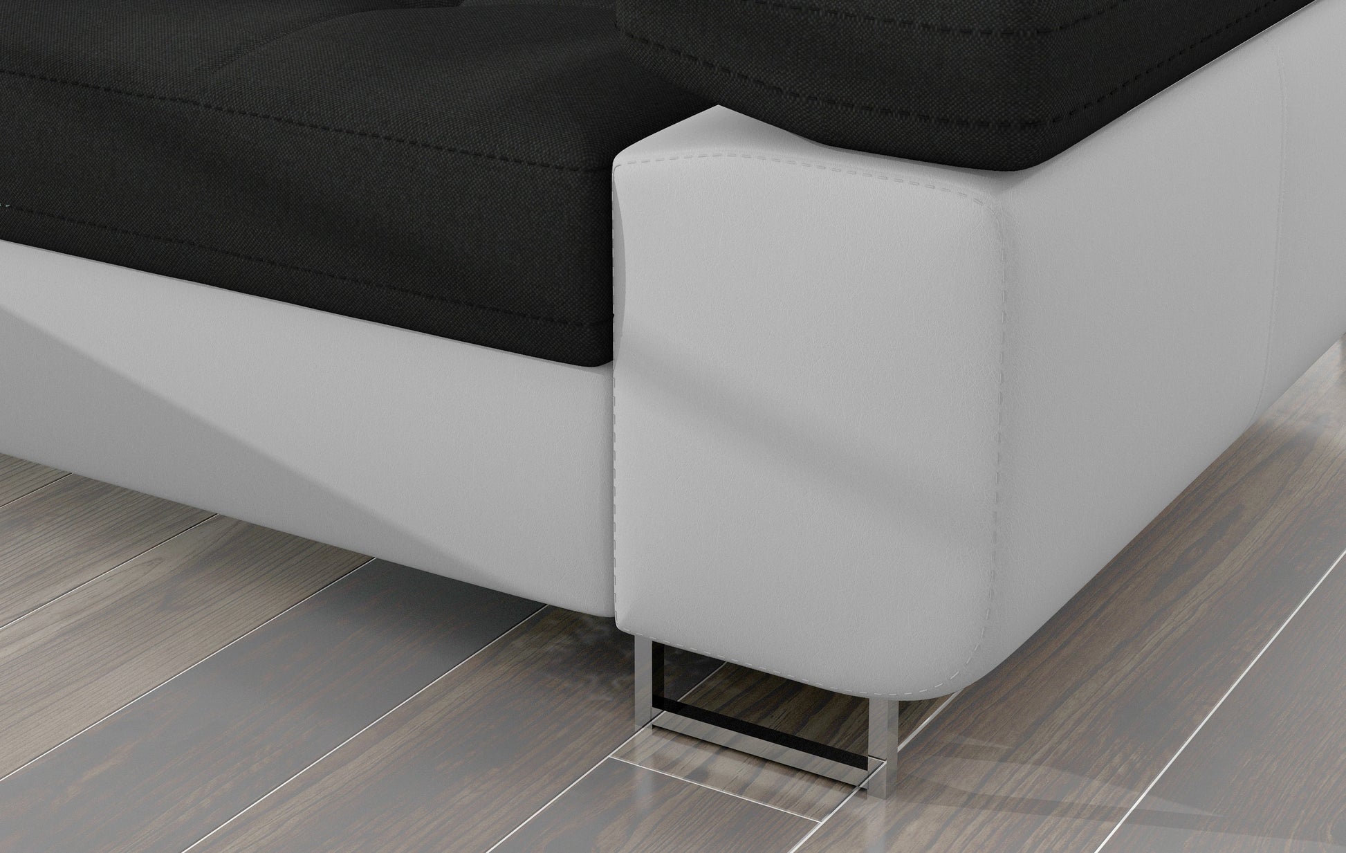Detal narożnika Armando: czarna tkanina Sawana 14 i biała podstawa Soft 17 – widok narożnika z metalową nogą.