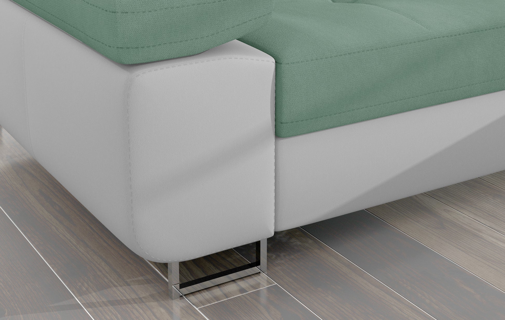 Detal narożnika Armando: biała podstawa Soft 17 i chromowana metalowa noga, kontrastująca z jasnozieloną tapicerką.