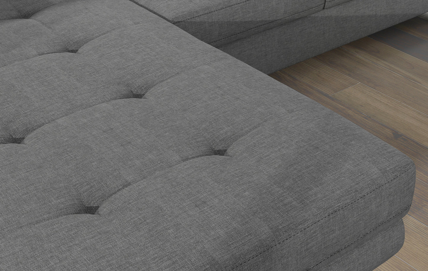 Zbliżenie na pikowane siedzisko narożnika Armando w tkaninie Cover 83 szary – wyraźna faktura materiału i poduszka Jungle 37.