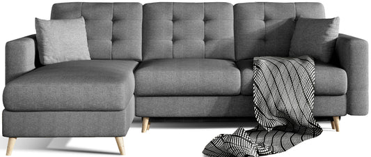 Narożnik Asgard L w kolorze Sawana 05 ciemnoszary, uniwersalny układ, widok frontowy na białym tle z dekoracyjnym pledem i poduszkami.