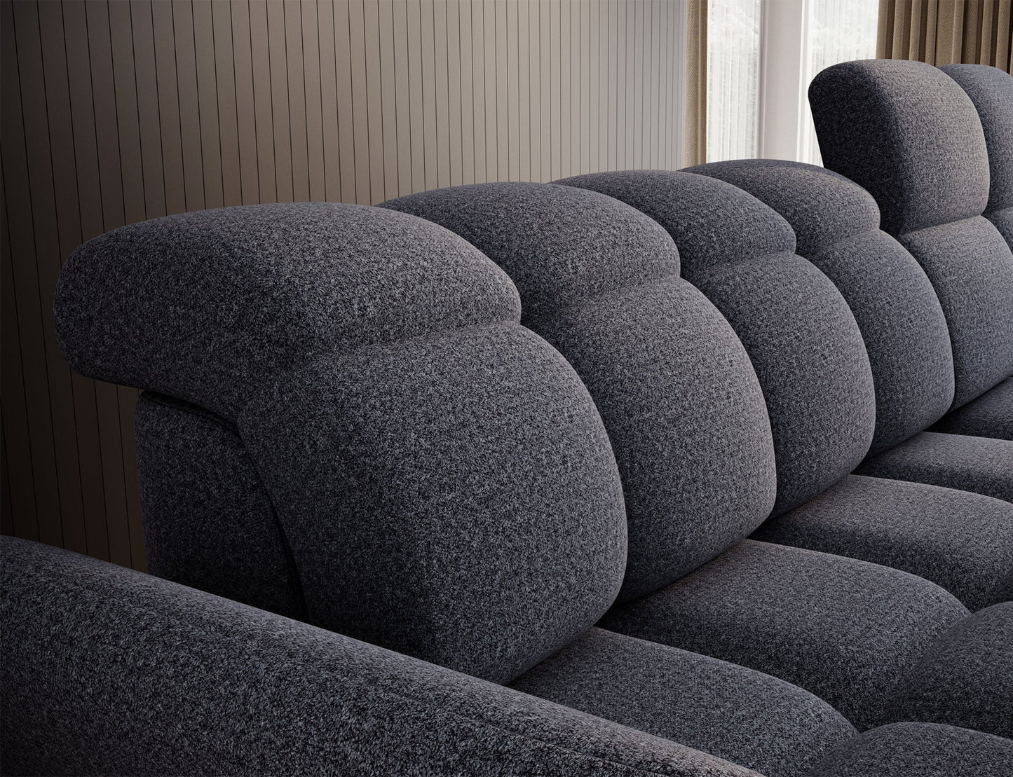 Ciemnoszary narożnik w przestronnym salonie, komponujący się z eleganckim wystrojem i neutralną kolorystyką wnętrza.