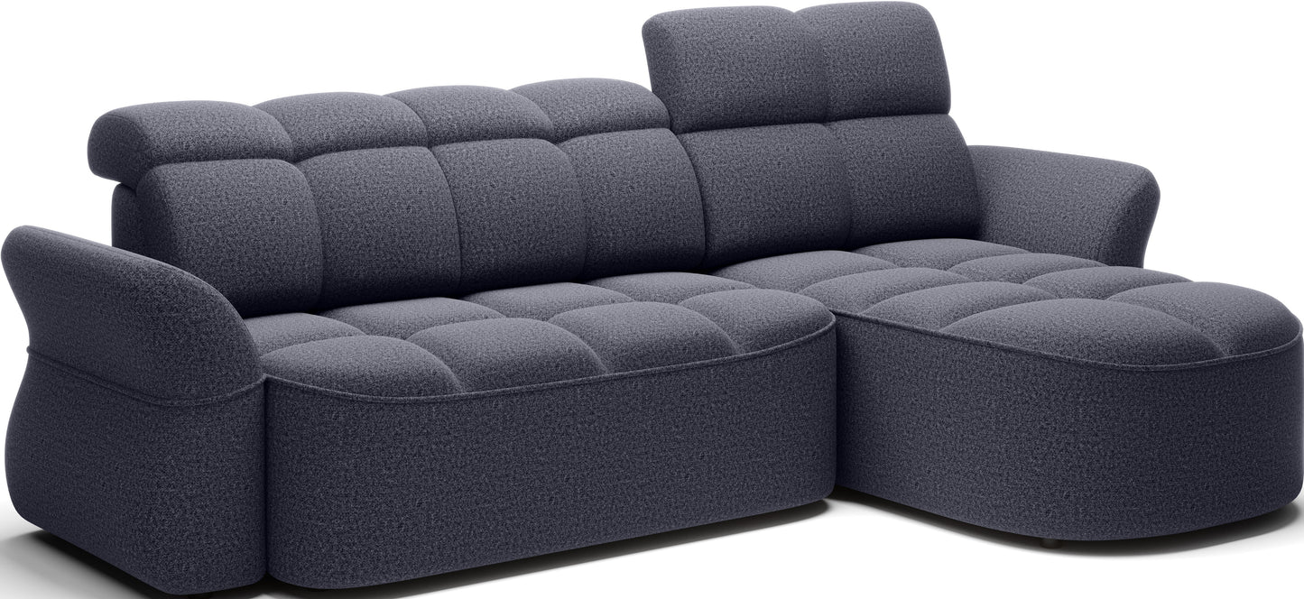 Nowoczesny narożnik w ciemnoszarym tapicerowaniu, z zaokrąglonymi podłokietnikami i komfortowym siedziskiem.