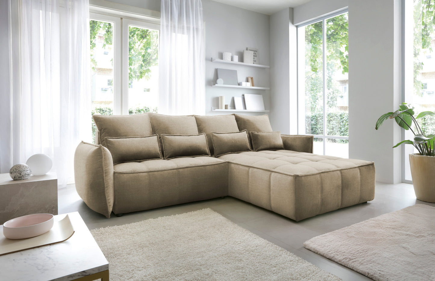 Narożnik Campo w układzie prawym, tapicerka Nube 04 szary, widok z boku w nowoczesnym wnętrzu z dywanem i minimalistycznymi półkami na ścianie.