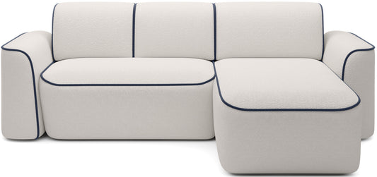 Sofa Ume narożna w układzie prawym, tapicerka bouclé Royal 01 biały z kontrastową lamówką Velvetmat 40 granatowy.