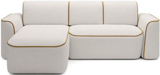 Przód narożnika Ume w układzie lewym, tapicerka bouclé Royal 01 biały z kontrastową lamówką Riviera 41 żółty na białym tle.