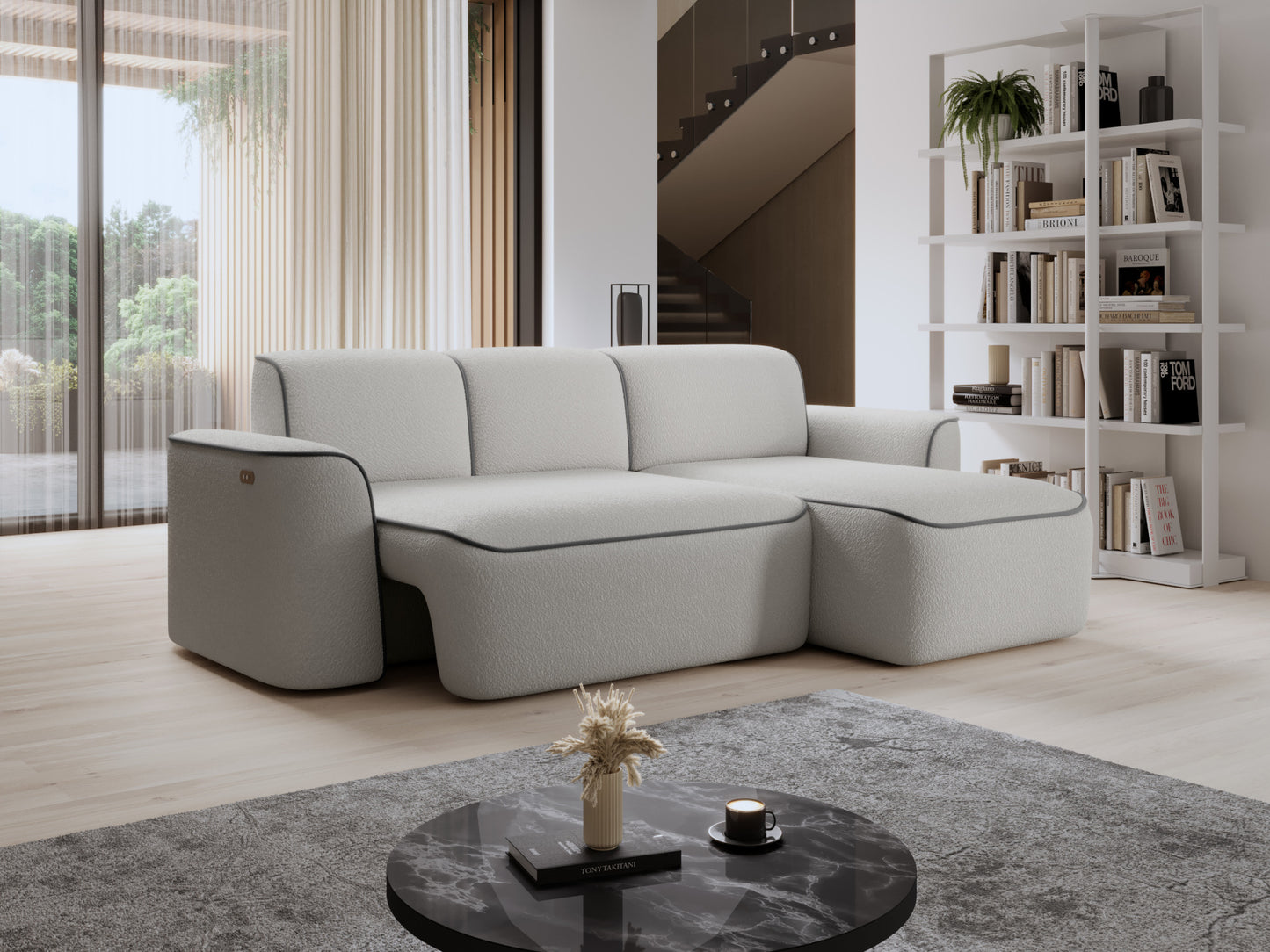 Sofa narożna Ume z prawą otomanką przy regale na książki i schodach w tle, biała bouclé z szarą obwódką.