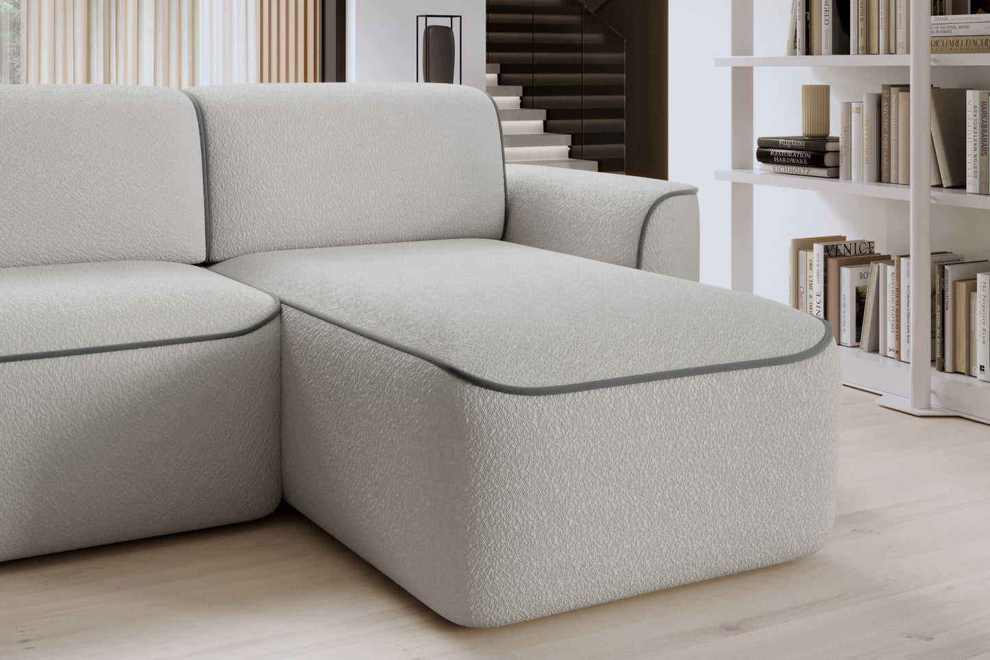 Zbliżenie na oparcie i siedzisko prawej otomanki Ume we wnętrzu, tapicerka bouclé Royal 03 biały z lamówką Velvetmat 04 szary.