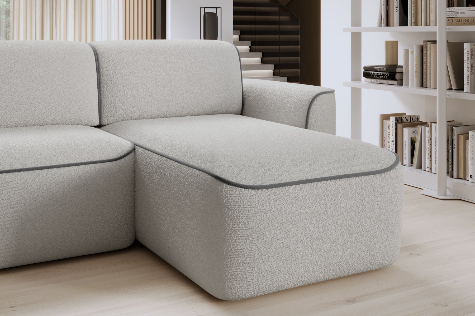 Zbliżenie na oparcie i siedzisko prawej otomanki Ume we wnętrzu, tapicerka bouclé Royal 03 biały z lamówką Velvetmat 04 szary.