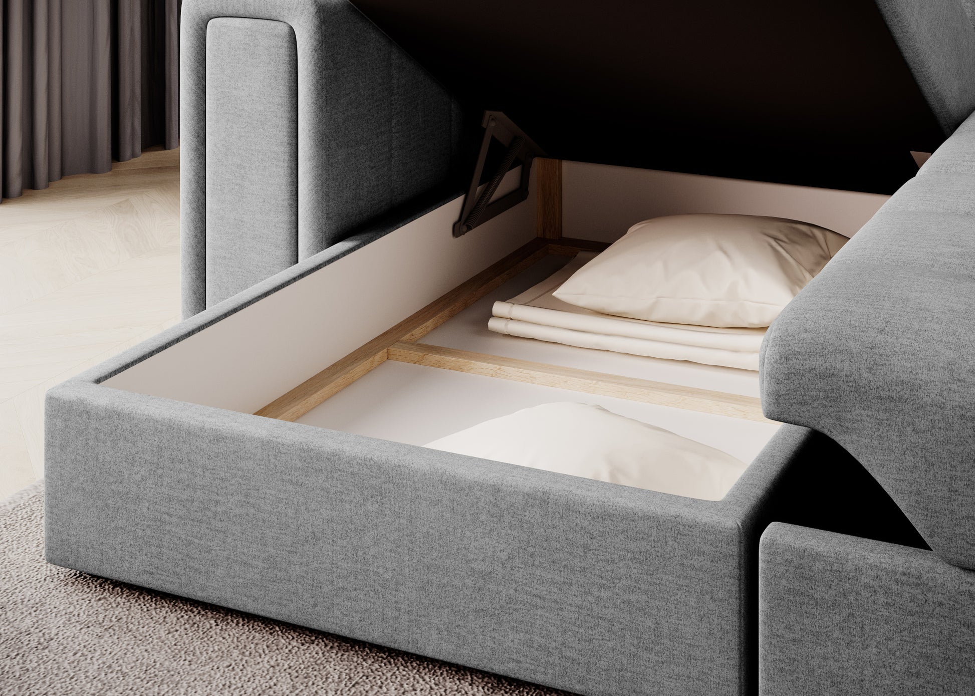 Pojemnik na pościel w narożniku Blenvi w tkaninie Monolith 84 jasnoszary, otwarty, z widocznymi poduszkami i kocem w środku.