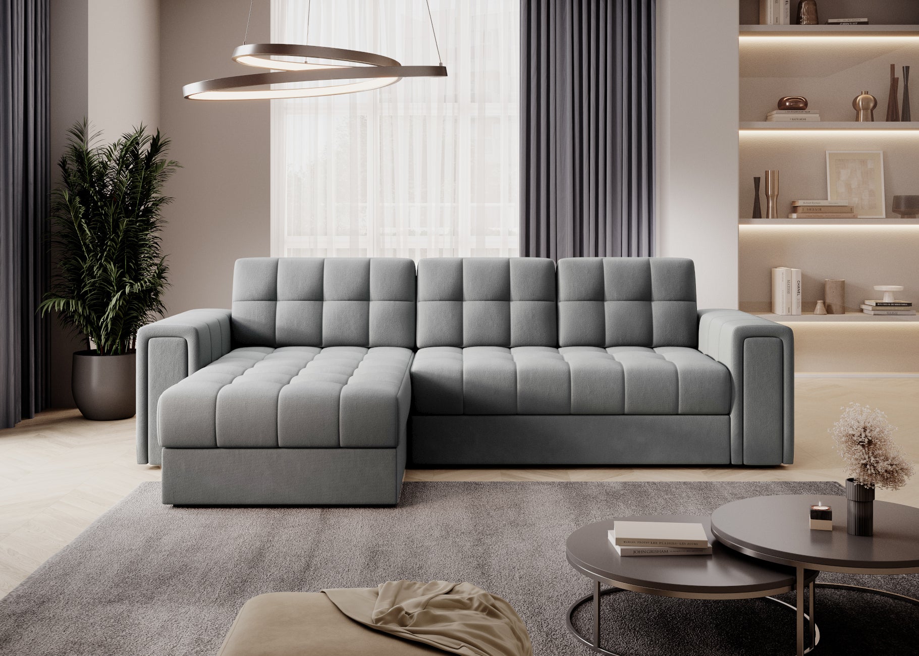 Szara sofa narożna z pikowanym siedziskiem i oparciem, nowoczesny salon z regałem, zasłonami i okrągłymi stolikami kawowymi.