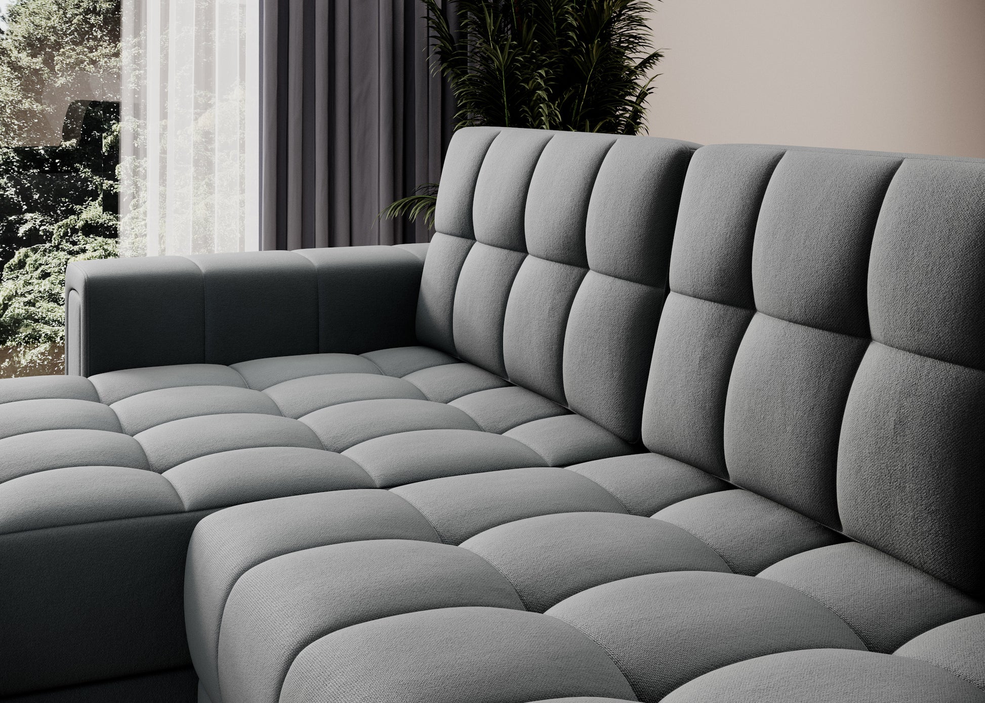 Zbliżenie na tapicerkę sofy narożnej w tkaninie Sola 06 szary – pikowane siedzisko i oparcie w eleganckim, nowoczesnym wnętrzu.