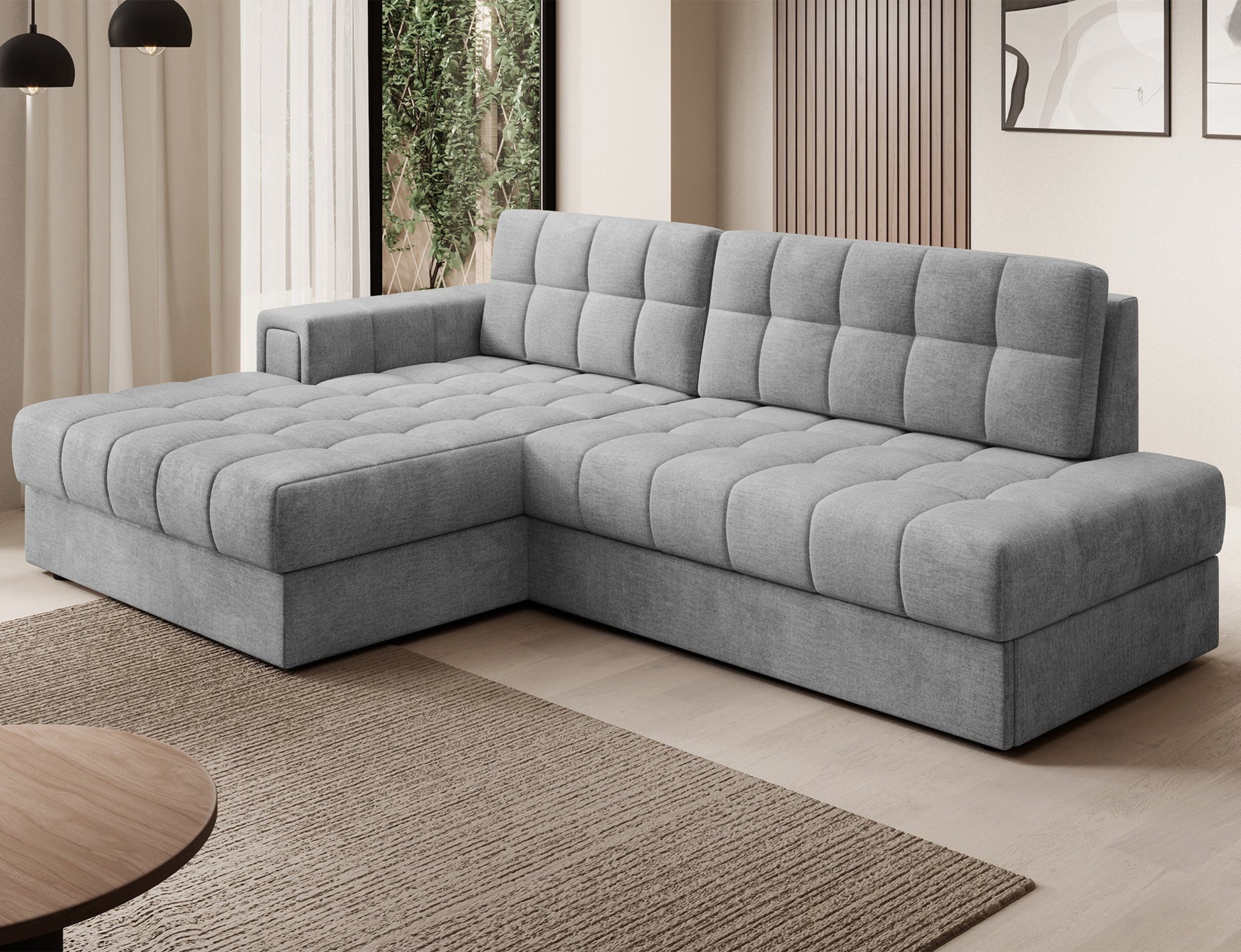 Narożnik Blezalt lewy Monolith 85 w szarym kolorze, w nowoczesnym salonie, z pikowanym siedziskiem i podłokietnikiem.