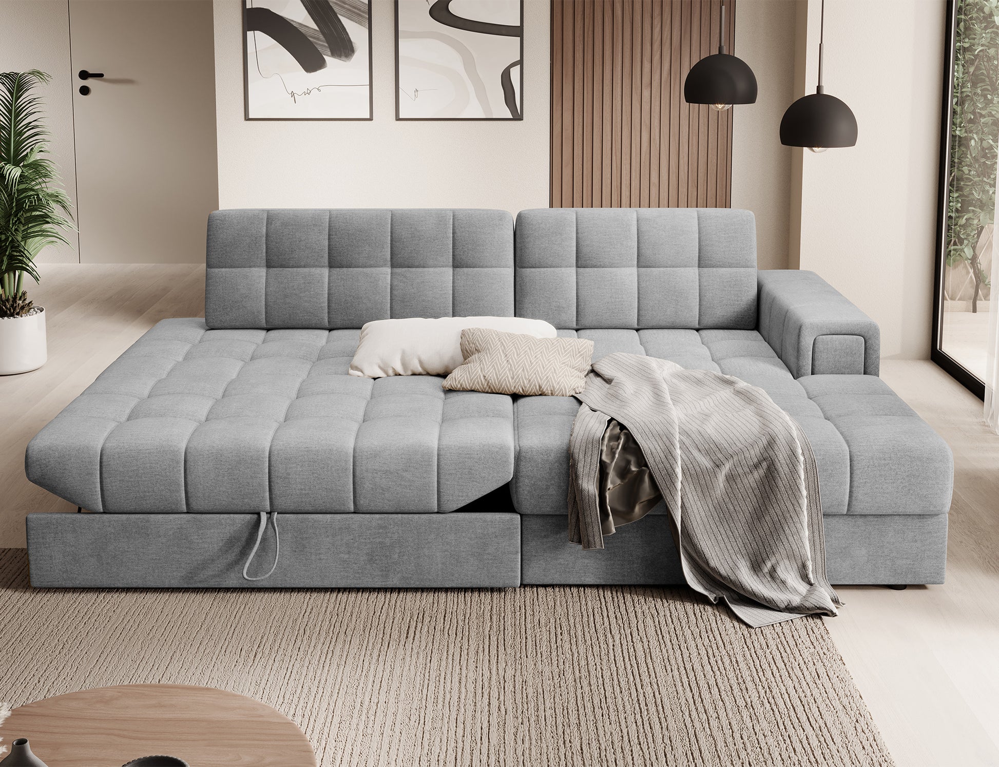 Szary narożnik Blezalt Monolith 85 prawy w funkcji spania, z rozłożonym siedziskiem i wysuniętą szufladą, w nowoczesnym salonie.