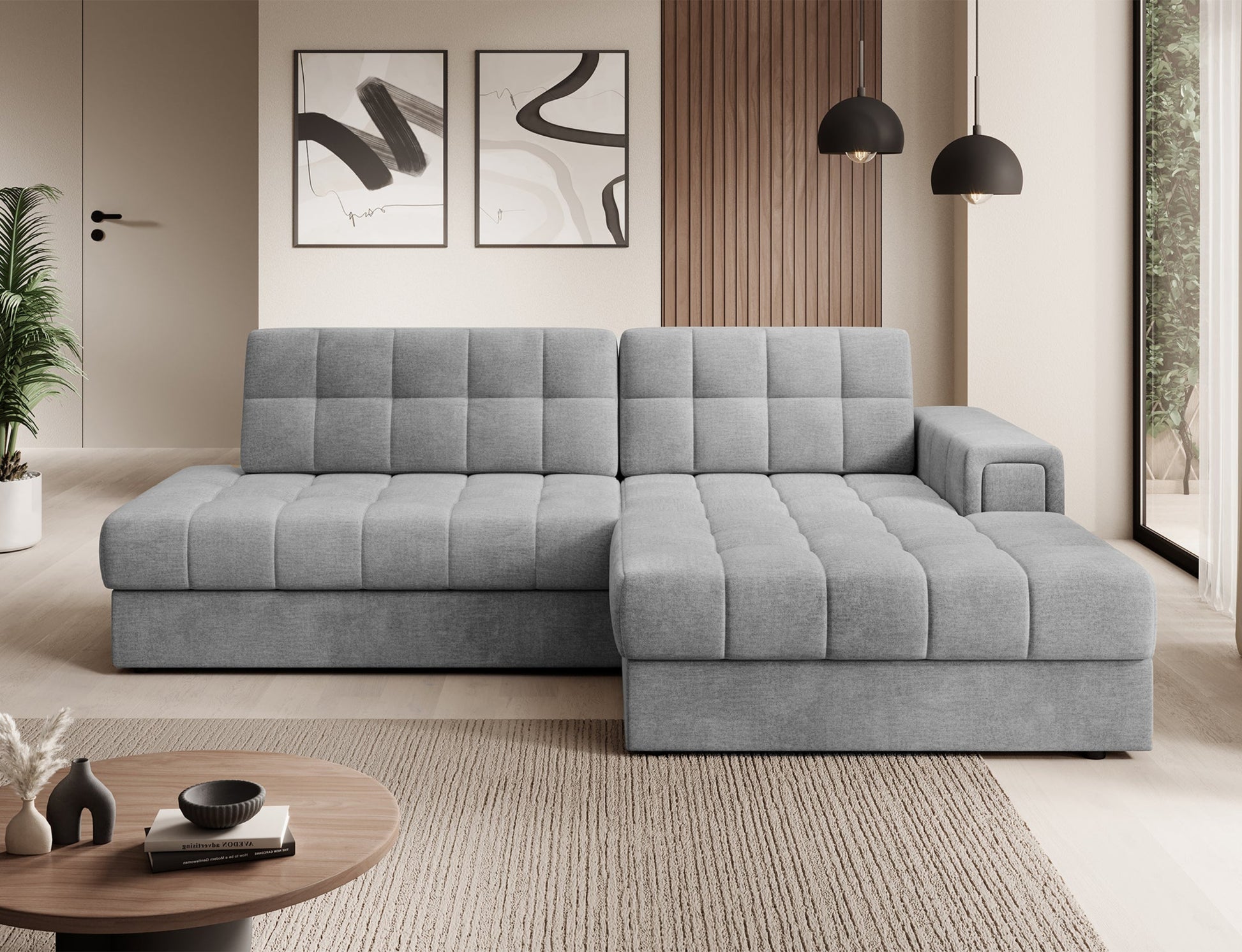 Szary narożnik Blezalt Monolith 85 prawy w nowoczesnym salonie, pikowany, z szerokim podłokietnikiem, ustawiony przy ścianie.