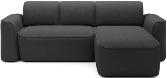 Narożnik Ume w układzie prawym z szezlongiem po prawej stronie, tapicerka bouclé Royal 05 czarny z lamówką Velvetmat 06 ciemnoszary na białym tle.