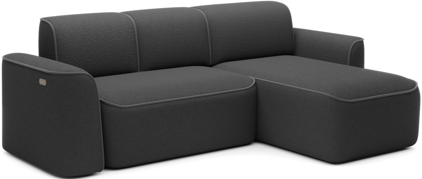 Ukośny widok narożnika Ume w układzie prawym na białym tle, tapicerka Royal 05 czarny i lamówka Velvetmat 04 szary.