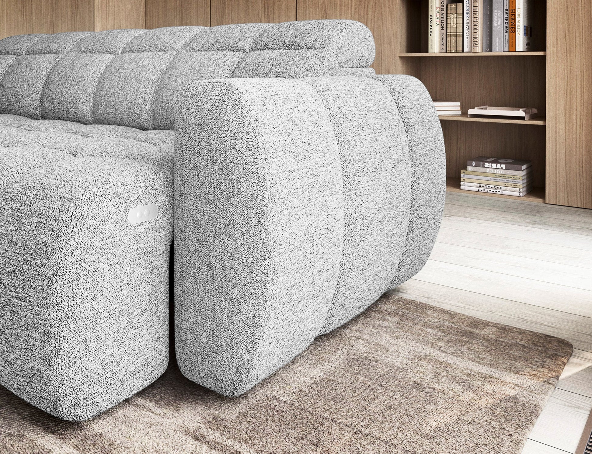 Boczny widok narożnika Falconn Coralline 01 z tkaniny bouclé, z widocznym portem USB i zaokrąglonym podłokietnikiem.