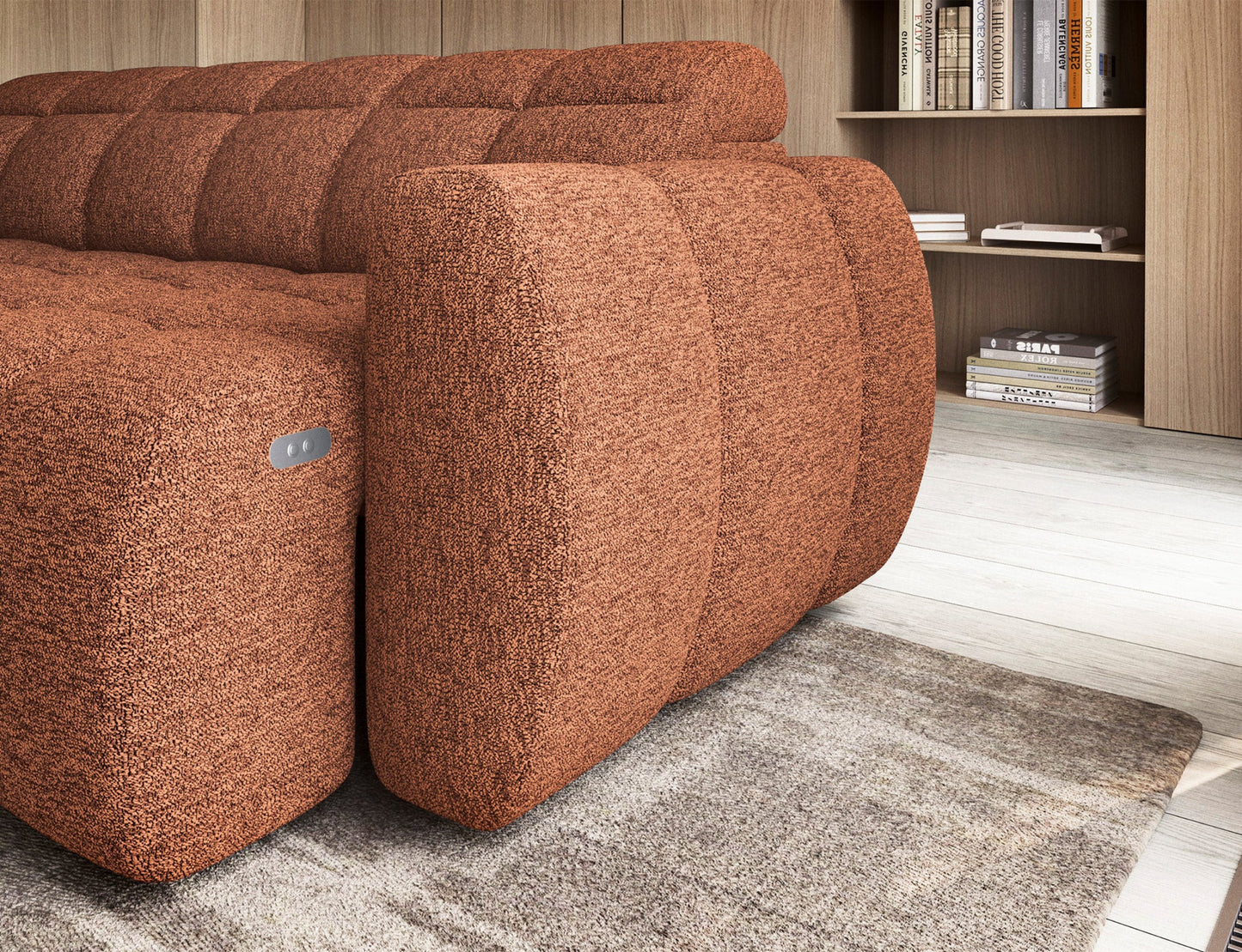 Zbliżenie na boczek narożnika Falconn w tkaninie Coralline 30, kolor ceglasty, z widocznym przyciskiem do regulacji siedziska.