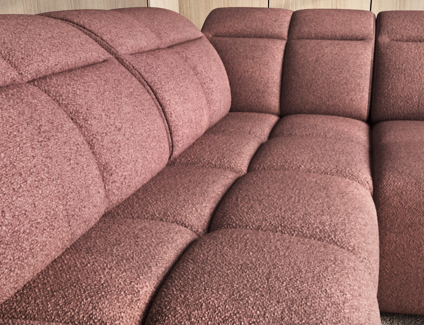 Zbliżenie na różowe siedzisko narożnika Falconn Paolli 24, widoczne pikowane poduszki, tło z jasnym drewnem i regałem.