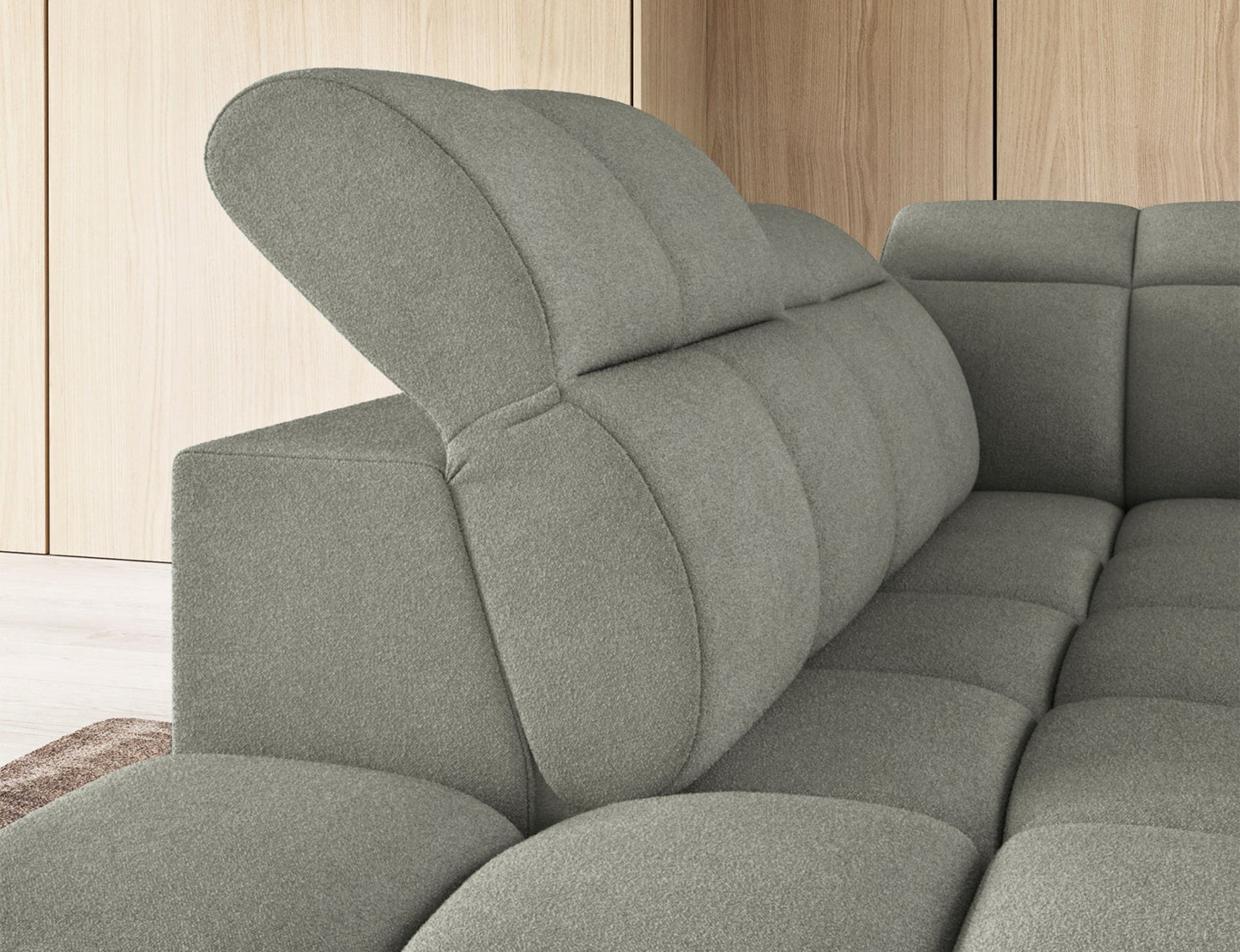 Jasnozielony narożnik Falconn Xillar 100, zbliżenie na regulowany zagłówek w pozycji podniesionej, eksponujący miękkie, pikowane oparcie.