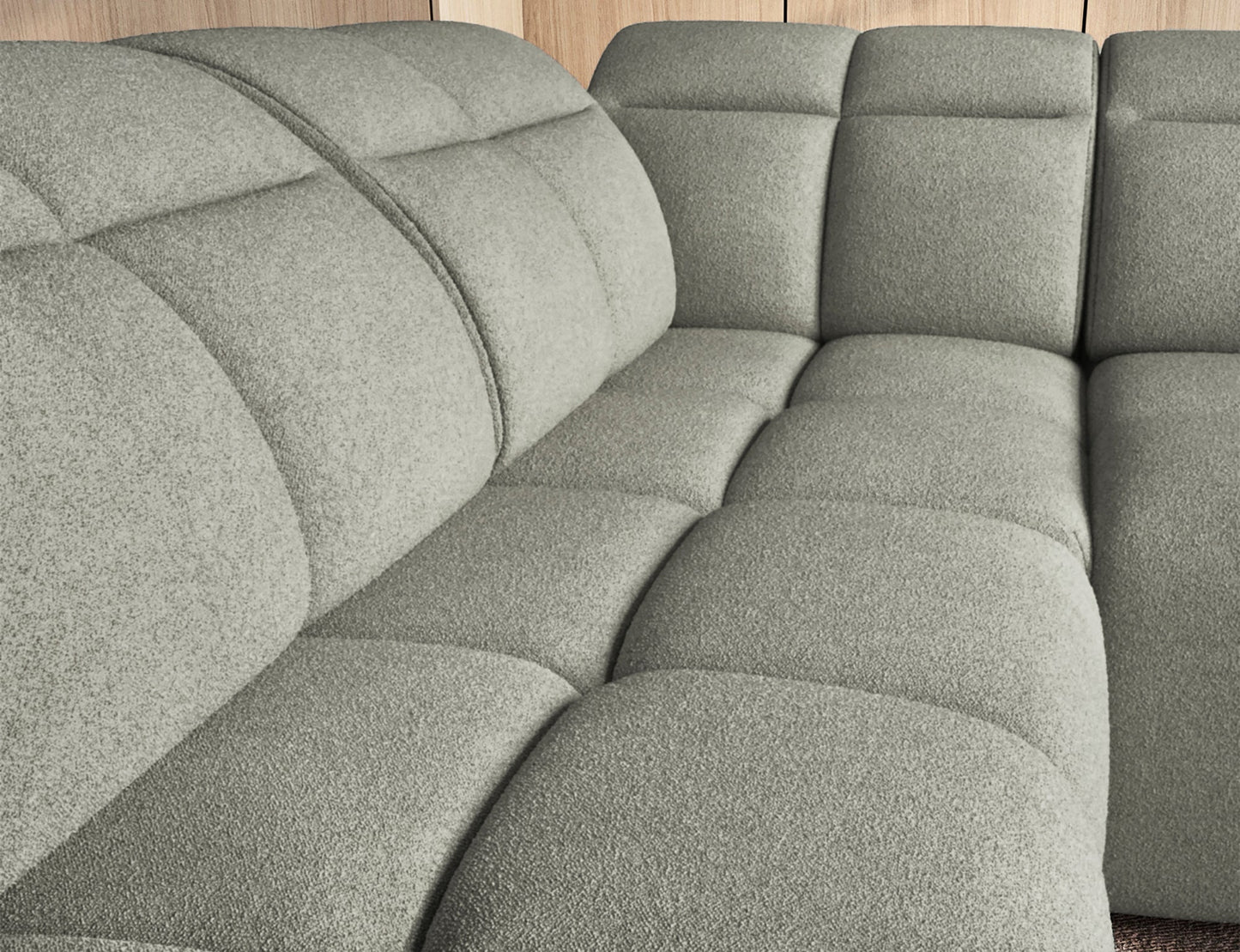 Jasnozielony narożnik Falconn Xillar 100, zbliżenie na głęboko pikowane siedziska i oparcia, podkreślające miękkość i komfort tkaniny.