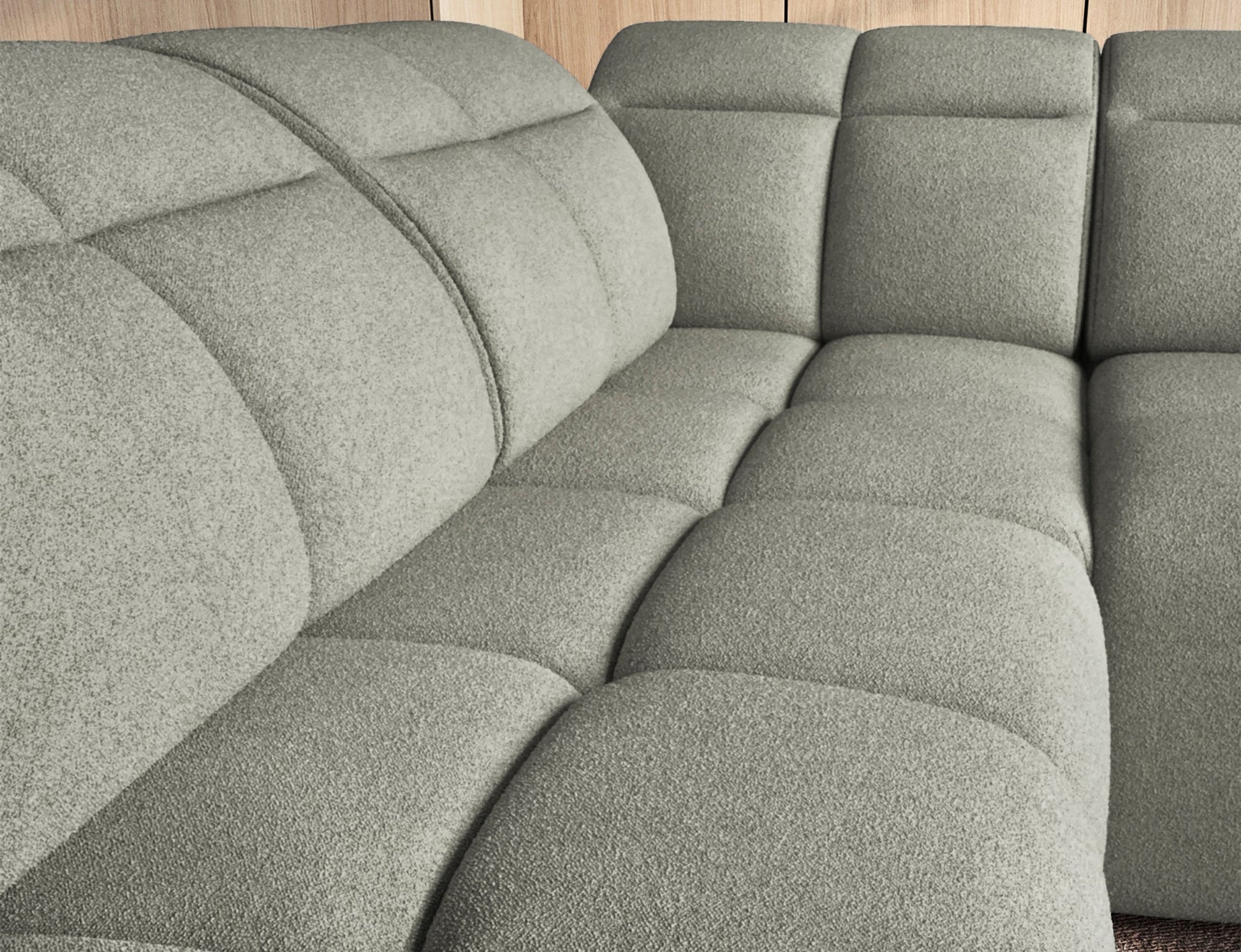 Jasnozielony narożnik Falconn Xillar 100, zbliżenie na głęboko pikowane siedziska i oparcia, podkreślające miękkość i komfort tkaniny.