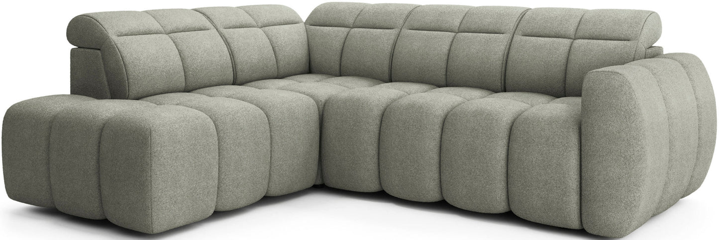 Narożnik Falconn Xillar 100 w kolorze jasnozielonym, widok z ukosa, miękkie modułowe siedziska i oparcia z wyrazistymi przeszyciami oraz zaokrąglonymi kształtami.