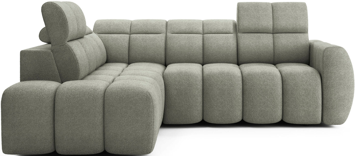 Nowoczesny narożnik Falconn Xillar 100 w kolorze jasnozielonym, widok od frontu, modułowa konstrukcja, regulowane zagłówki, miękkie pikowane siedziska.