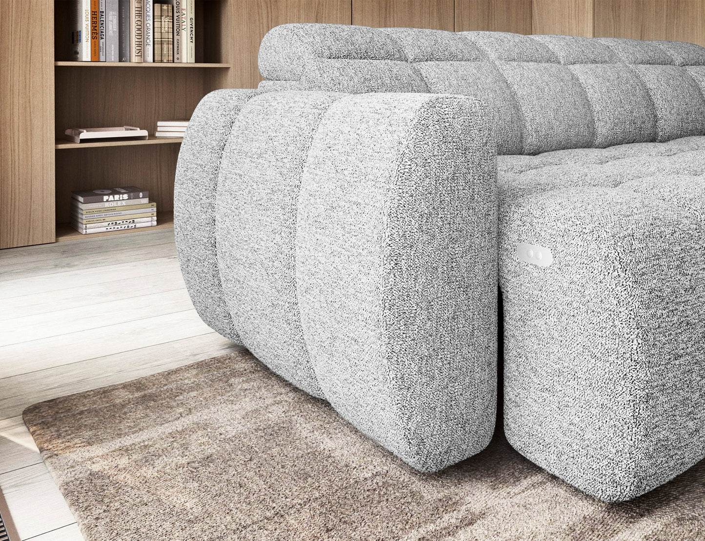 Narożnik Falconn Coralline 01 w białym odcieniu, zbliżenie na boczną część sofy z widocznym przyciskiem sterującym funkcjami mebla.