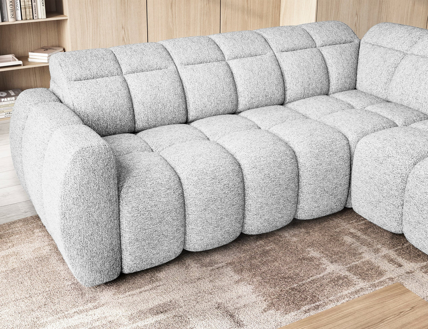 Narożnik Falconn Coralline 01 w białej tkaninie, ujęcie zbliżeniowe na wsunięte siedziska oraz boczną część sofy w nowoczesnym salonie.