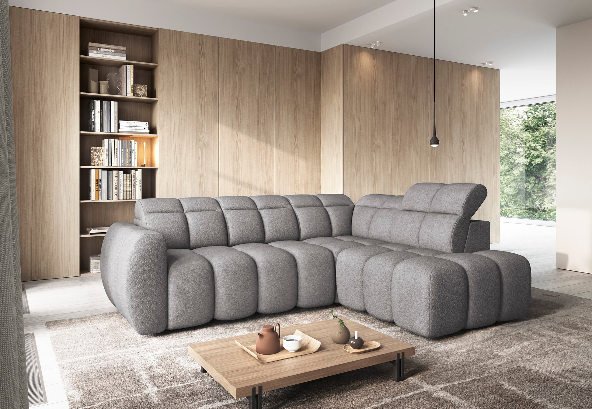 Nowoczesny narożnik Falconn w tkaninie Paolli 04 w kolorze szarym, ustawiony w jasnym salonie, widok z ukosa