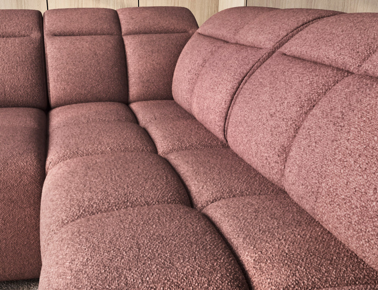 Zbliżenie na głęboko pikowane siedzisko narożnika Falconn Paolli 24 w tkaninie różowej, podkreślające miękkie linie i strukturę.