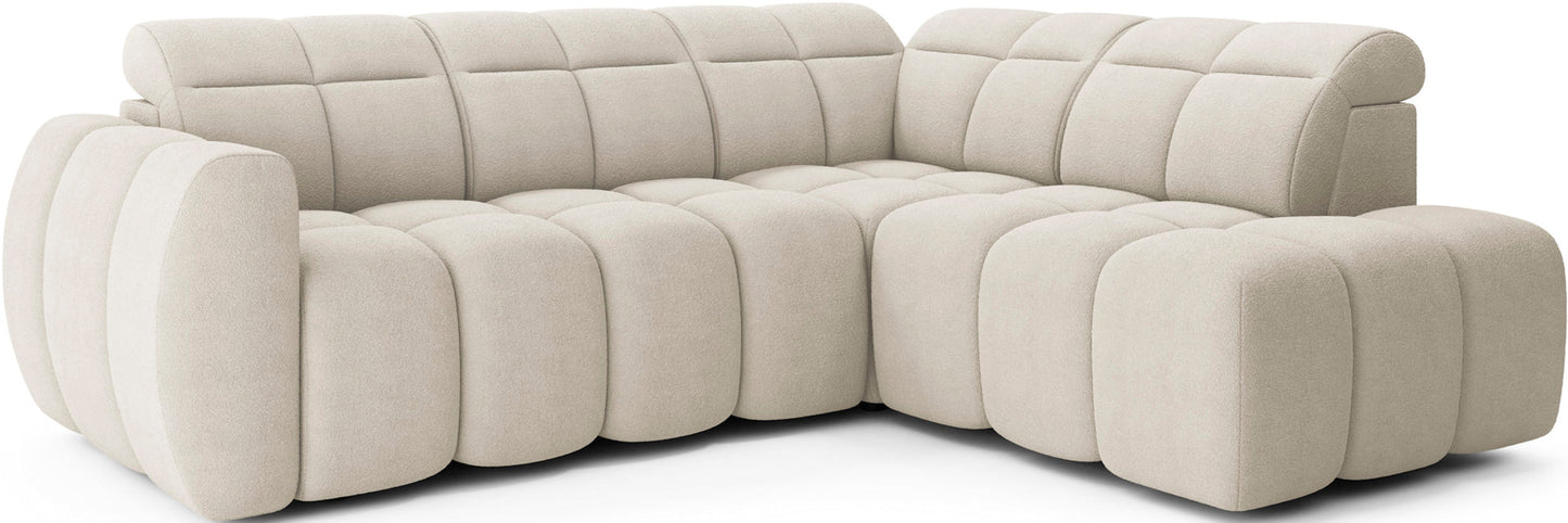 Narożnik Falconn Royal 18 w kremowej tkaninie, o obłych, modułowych siedziskach i regulowanych zagłówkach, widok skośny na całość bryły.